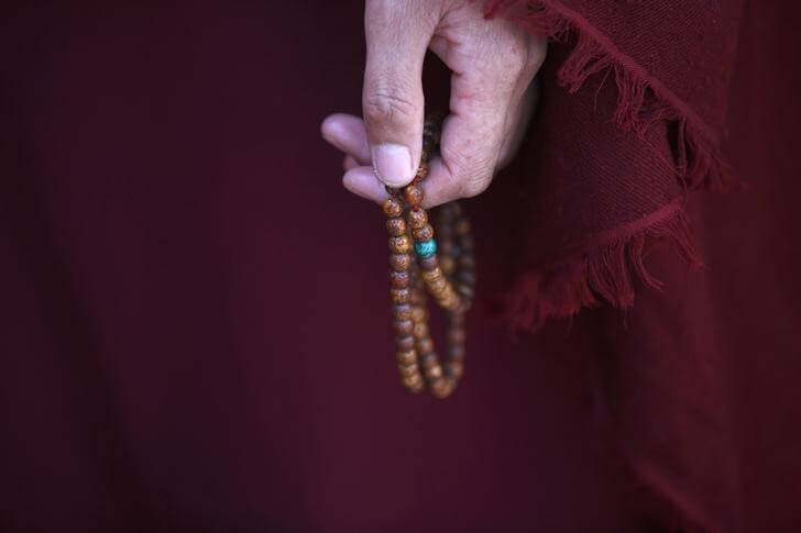 A Tibetan nun holds prayer beads during a function organised by the Tibetan Refugee Community in Nepal commemorating the 25th Anniversary of the Nobel Peace Prize conferment to exiled Tibetan spiritual leader Dalai Lama and the 66th International Human Rights Day in Kathmandu December 10, 2014. REUTERS/Navesh Chitrakar/Files