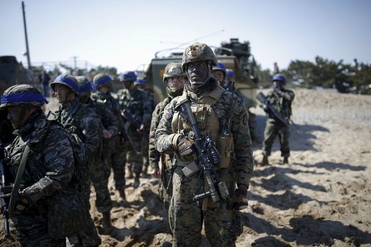 South Korean (blue headbands) and U.S. Marines take part in a U.S.-South Korea joint landing operation drill in Pohang, South Korea, March 12, 2016. REUTERS/Kim Hong-Ji