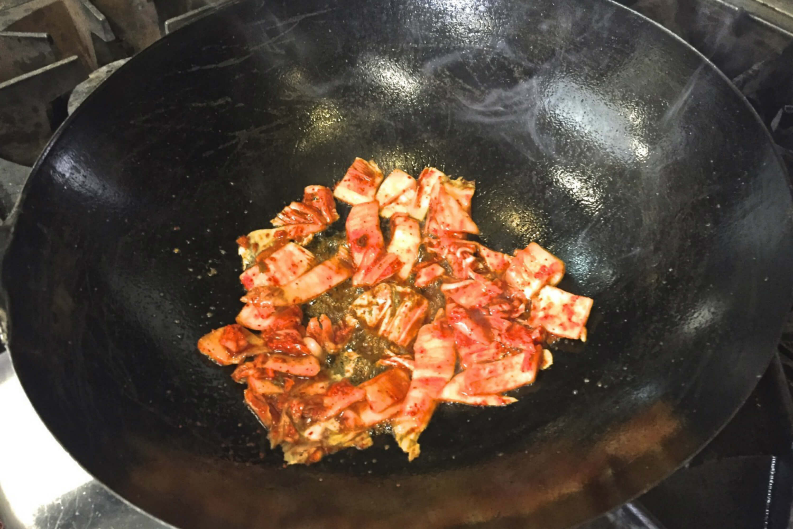Kimchi in a wok to make kimchi fried rice at Hanjip. Credit: Copyright 2016 David Latt