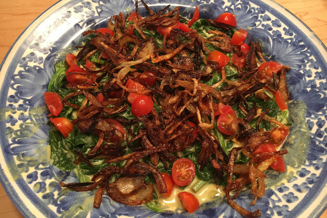 A New Delhi-style curried spinach has coconut milk, tomatoes and fried onions. Credit: Copyright 2016 Marie Simmons
