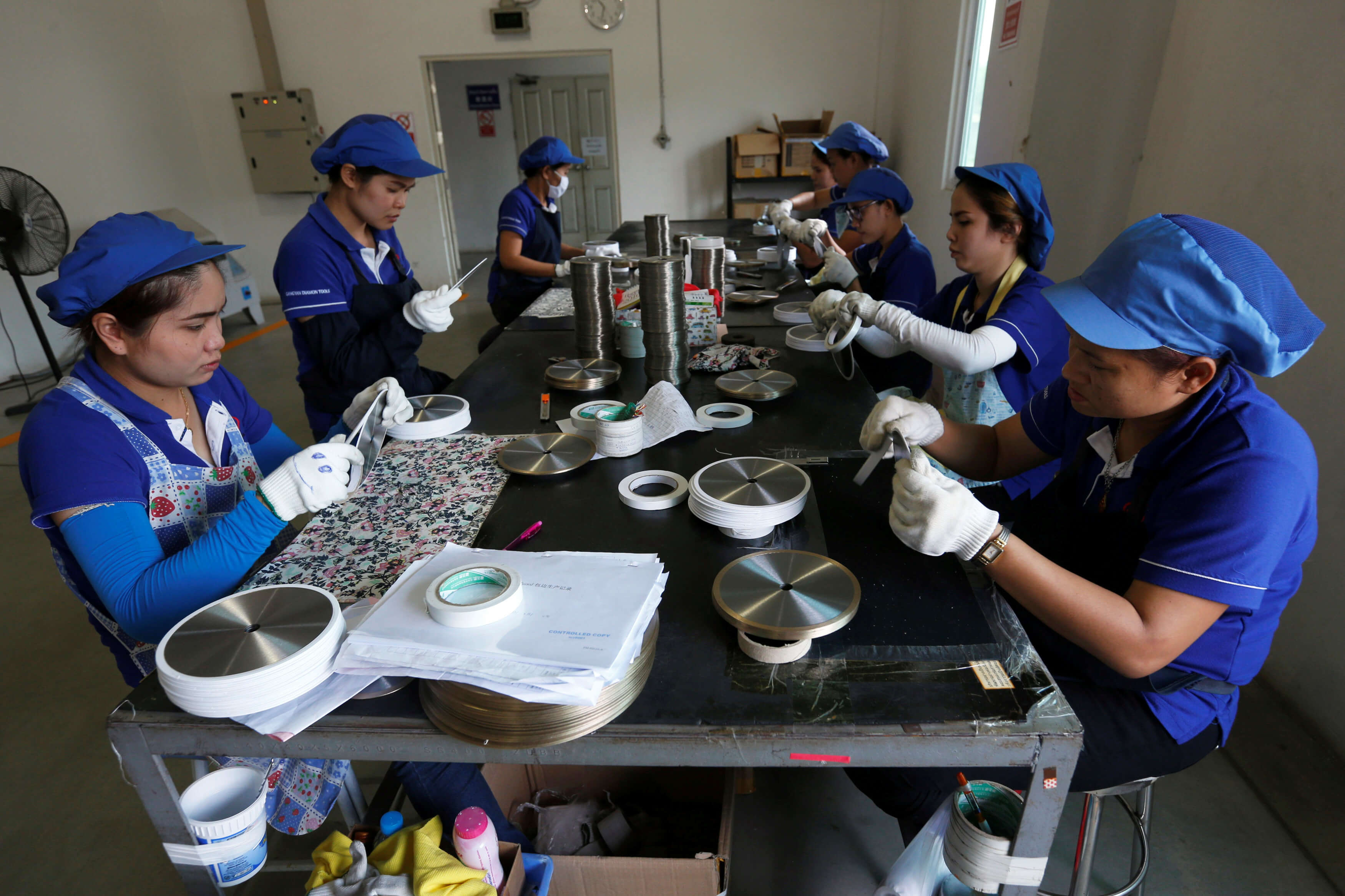 Employees arrange blades for construction at an assembly line at Gang Yan Diamond Tools, a Chinese manufacturing plant, located in the Thai-Chinese Rayong Industrial Zone in Rayong province, east of Bangkok, Thailand, April 7, 2016. REUTERS/Chaiwat Subprasom