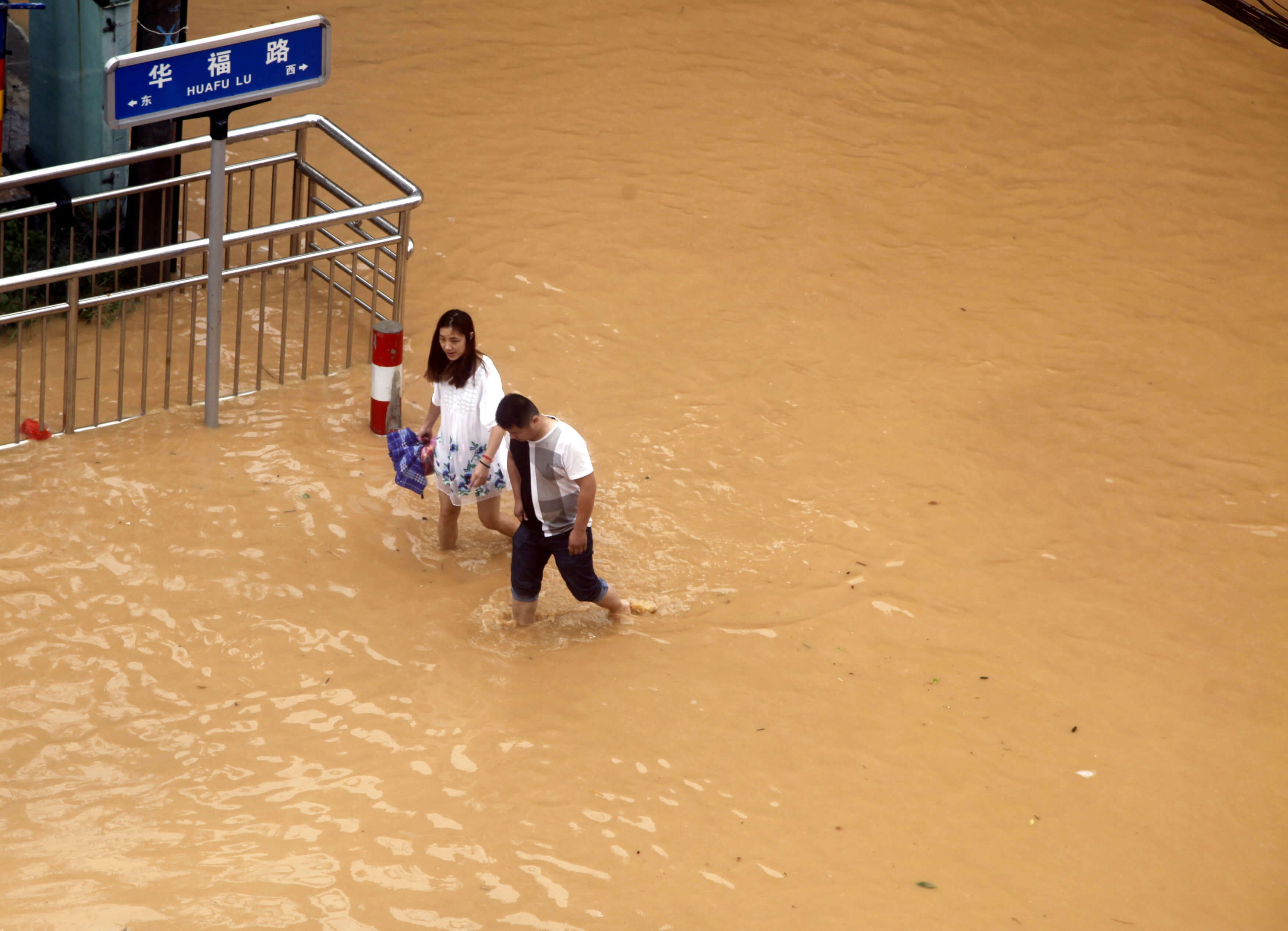 Residents walk at a flooded area as Typhoon Nepartak brings heavy rainfall in Putian, Fujian Province, China, July 9, 2016. REUTERS/Stringer